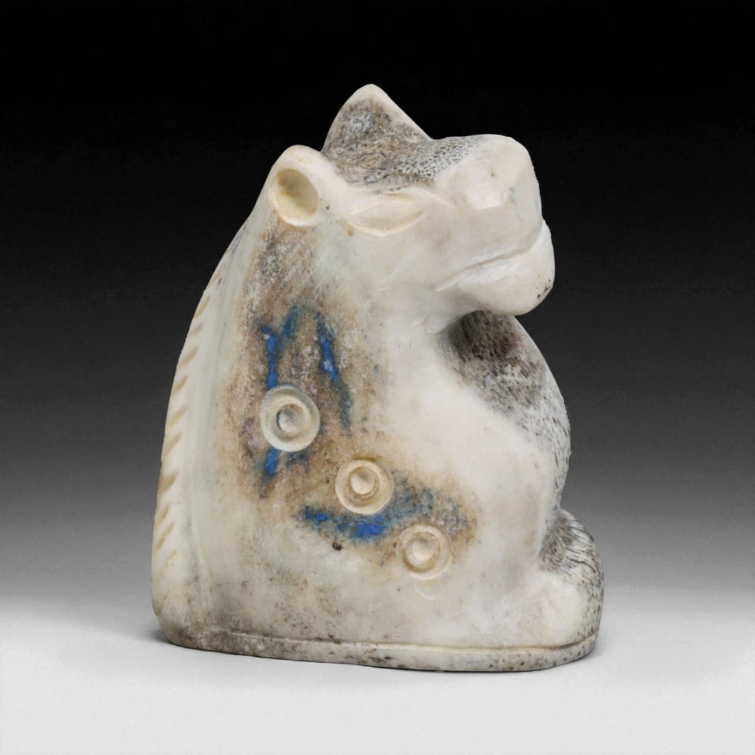 Ancient Near Eastern Carved Bone Animal Effigy, c. 2nd-1st Millennium BCE 35g: This finely carved bone effigy, measuring 5 x 4 cm and weighing 35 grams, represents the stylized head and upper body of an animal, likely a horse or bull, both revered creatures in the Ancient Near E