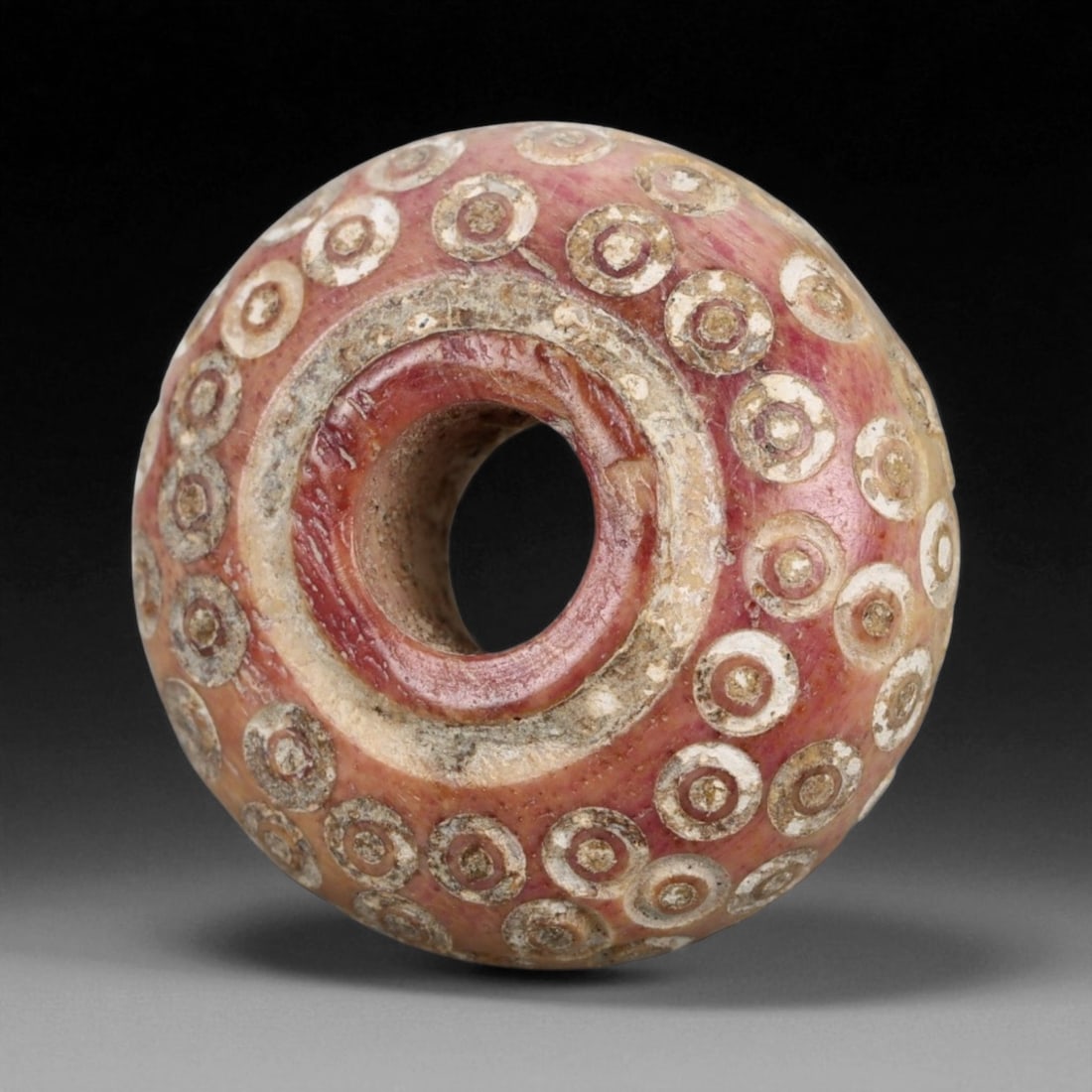 Ancient Medieval Nishapur Silk Road Bone Spindle Whorl, c. 9th-11th Century CE, 1.6cm: This finely carved spindle whorl originates from Nishapur, an important Silk Road city in medieval northeastern Iran, dating to approximately the 9th-11th century CE. Such spindle whorls were essentia