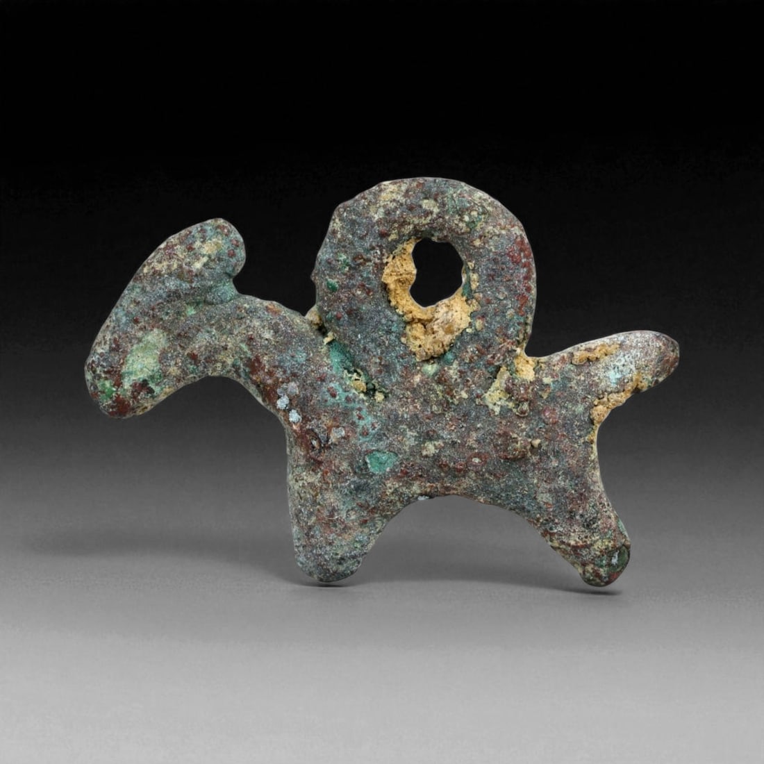 Ancient Luristan Bronze Goat Amulet, Iron Age, c. 1200-800 BCE, 2.1cm, 2g: This diminutive bronze amulet, depicts a stylized goat in profile, its arched horn clearly visible. Cast in solid bronze and smoothed by millennia of burial, the amulet now bears a rich green and eart