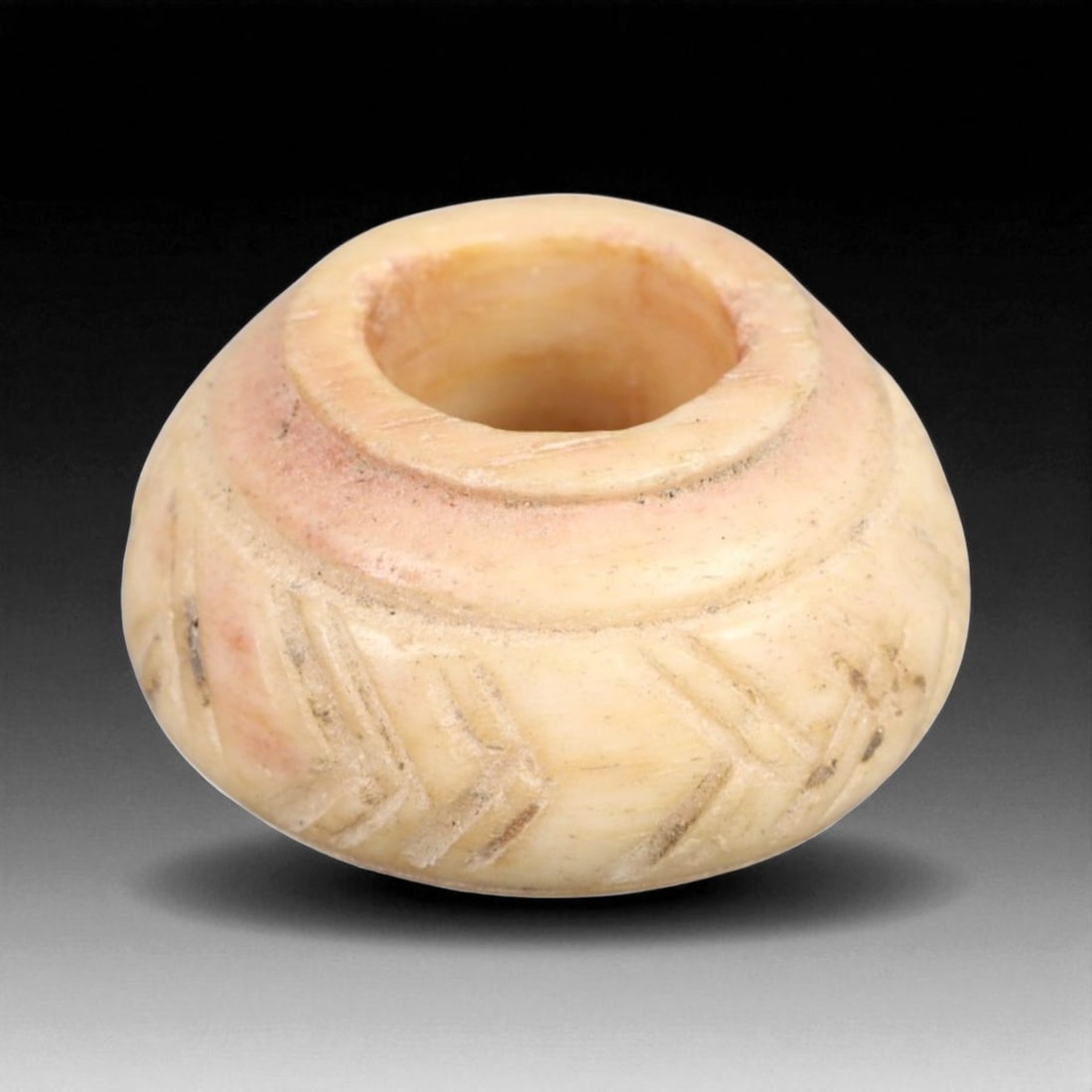Ancient Indus Valley Geometric Lattice Pattern Bone Spindle Whorl, c. 2600-1900 BCE, 1.4cm, 1.4g: This exceptional spindle whorl, carved from creamy bone and adorned with finely incised geometric motifs, originates from the mature phase of the Indus Valley Civilization-one of the world's earliest 