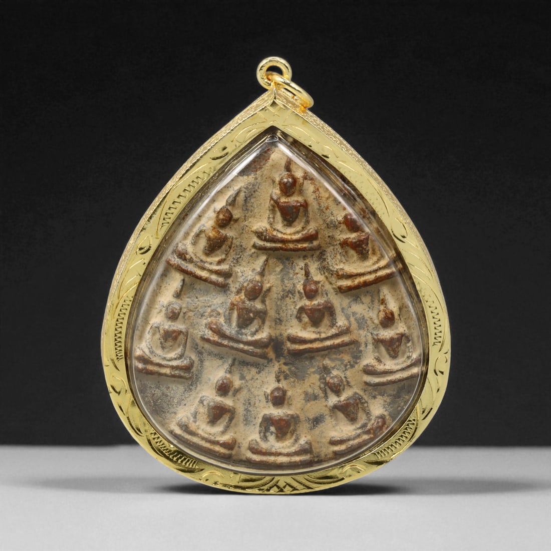 Thai Temple Gilt Buddhist Amulet in Ornate Gold-Tone Frame, 6.5cm: This beautifully crafted gilt Buddhist amulet is enclosed within an intricately designed gold-tone frame, combining sacred symbolism with refined artistry. The detailed relief and lustrous finish refl