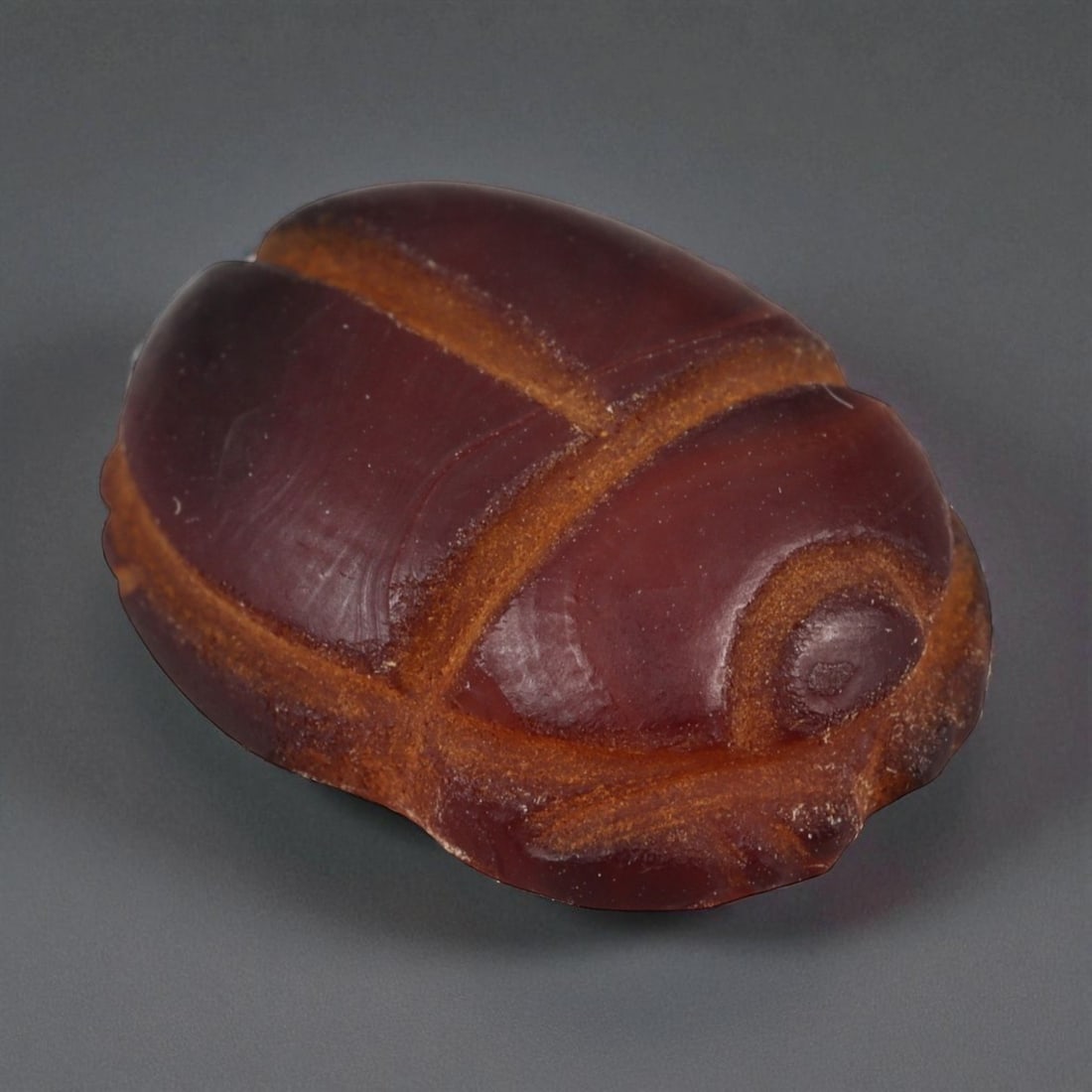 Ancient Egyptian Banded Agate Scarab Amulet, c. New Kingdom 16th-11th Century BCE (2 cm): This beautifully carved scarab amulet, fashioned from rich banded agate, dates to Egypt's New Kingdom period-a time when scarabs served as enduring emblems of protection, transformation, and rebirth. 