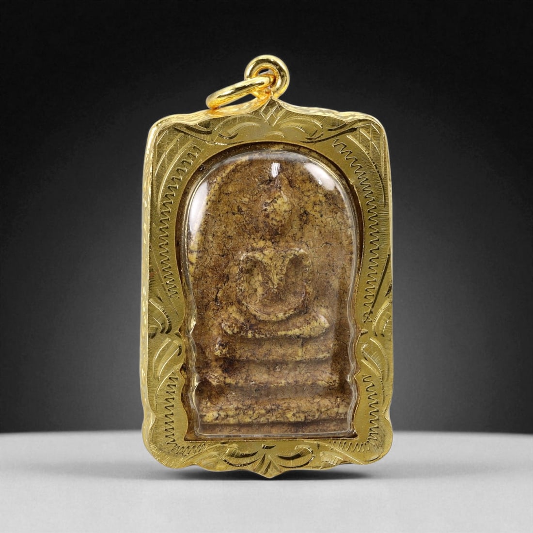 Thai Temple Style Gilt Buddhist Amulet in Ornate Gold-Tone Frame, 5cm: This beautifully crafted gilt Buddhist amulet is enclosed within an intricately designed gold-tone frame, combining sacred symbolism with refined artistry. The detailed relief and lustrous finish refl
