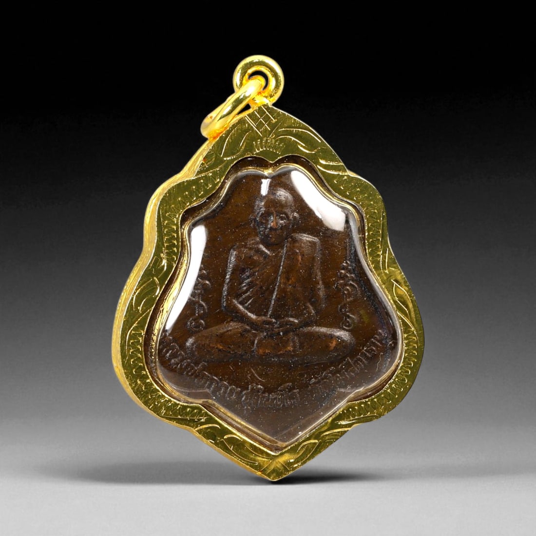 Thai Temple Style Gilt Buddhist Amulet in Ornate Gold-Tone Frame, 4.5cm: This beautifully crafted gilt Buddhist amulet is enclosed within an intricately designed gold-tone frame, combining sacred symbolism with refined artistry. The detailed relief and lustrous finish refl