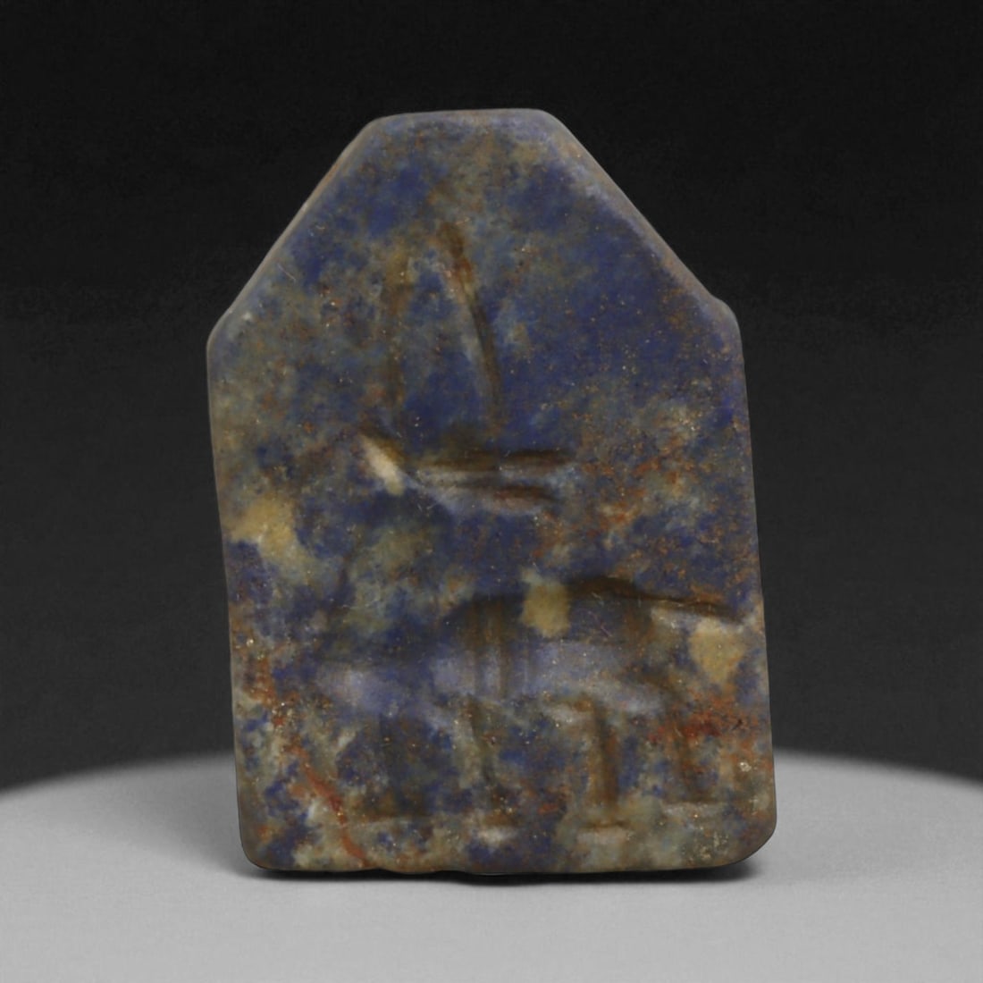 Ancient Mesopotamian Akkadian Lapis Lazuli Amulet with Ibex, c. 2300-2100 BCE 16g: This striking lapis lazuli amulet, measuring 3.3 cm (1.3 in) and weighing 16 g (0.56 oz), dates to the Akkadian period of Mesopotamia, c. 2334-2154 BCE. Finely carved in deep blue stone veined with go