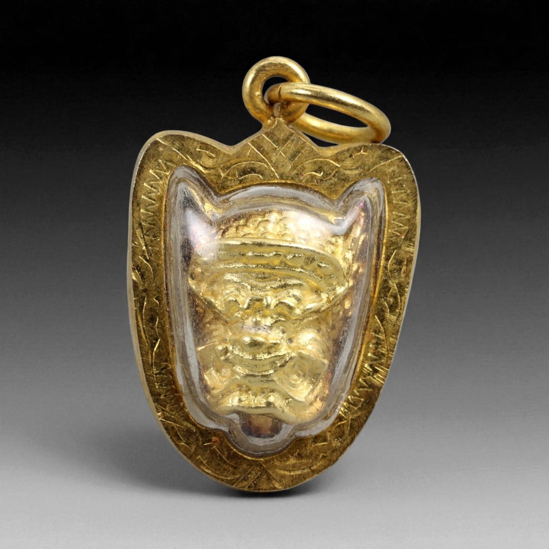 Thai Temple Gilt Buddhist Amulet in Ornate Gold-Tone Frame, 2.5cm: This beautifully crafted gilt Buddhist amulet is enclosed within an intricately designed gold-tone frame, combining sacred symbolism with refined artistry. The detailed relief and lustrous finish refl