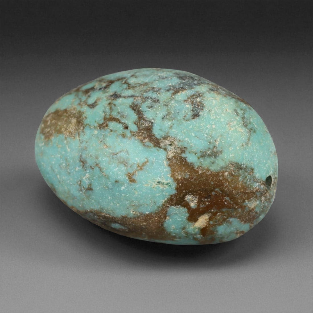 Antique Tibetan Mala Prayer Turquoise Amulet Bead, c. 18th-19th Century, 2.1cm, 6g: This striking turquoise bead from Tibet, dating to the 18th-19th century, embodies the deep spiritual and cultural reverence accorded to this precious stone in Himalayan tradition. Its organic, rounde