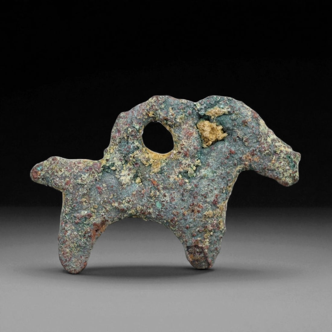 Ancient Luristan Bronze Goat Amulet, Iron Age, c. 1200-800 BCE, 2.2cm, 2.1g: This diminutive bronze amulet, depicts a stylized goat in profile, its arched horn clearly visible. Cast in solid bronze and smoothed by millennia of burial, the amulet now bears a rich green and eart