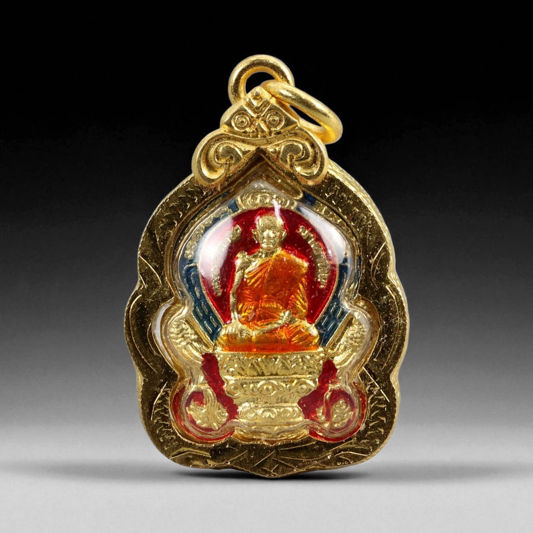 Thai Temple Gilt Buddhist Amulet in Ornate Gold-Tone Frame, 3cm: This beautifully crafted gilt Buddhist amulet is enclosed within an intricately designed gold-tone frame, combining sacred symbolism with refined artistry. The detailed relief and lustrous finish refl