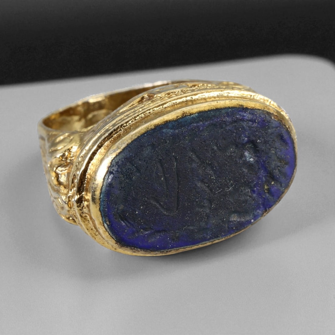 Antique Qajar Gold Gilt Intaglio Signet Ring, c. 19th-20th Century, 8 US, 22g: This substantial gilt ring, dating to the Qajar era of the 19th-20th century, embodies the regal aesthetic and cultural refinement of Persian jewelry traditions. The bezel is set with an engraved inta