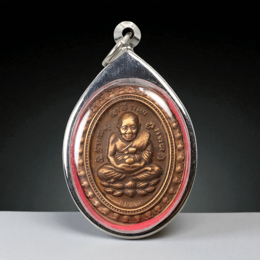 Vintage Thai Buddhist Amulet in Ornate Framed Setting, 20th Century, 5.5cm: This vintage Thai Buddhist amulet exemplifies the devotional artistry that continues to define Thailand's sacred craftsmanship. Encased within an intricately detailed frame, the amulet displays refine