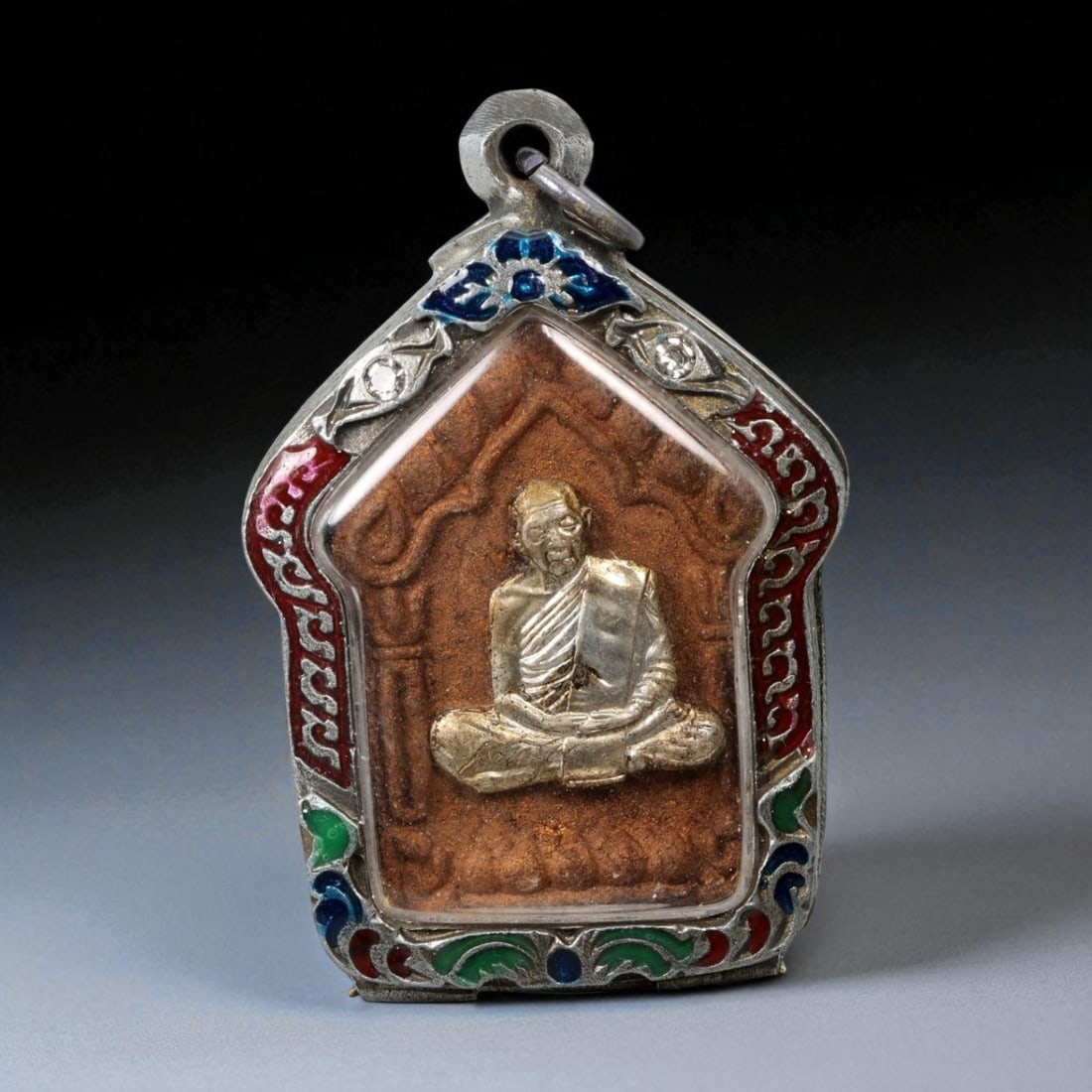 Vintage Thai Buddhist Amulet in Ornate Framed Setting, 20th Century, 6cm: This vintage Thai Buddhist amulet exemplifies the devotional artistry that continues to define Thailand's sacred craftsmanship. Encased within an intricately detailed frame, the amulet displays refine