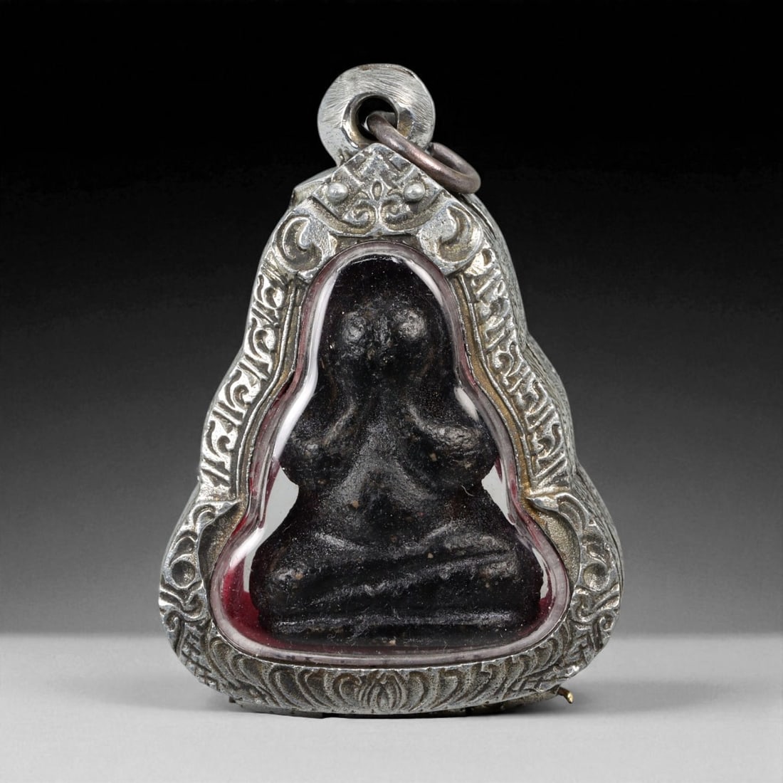 Vintage Thai Buddhist Amulet in Ornate Framed Setting, 20th Century, 5.5cm: This vintage Thai Buddhist amulet exemplifies the devotional artistry that continues to define Thailand's sacred craftsmanship. Encased within an intricately detailed frame, the amulet displays refine