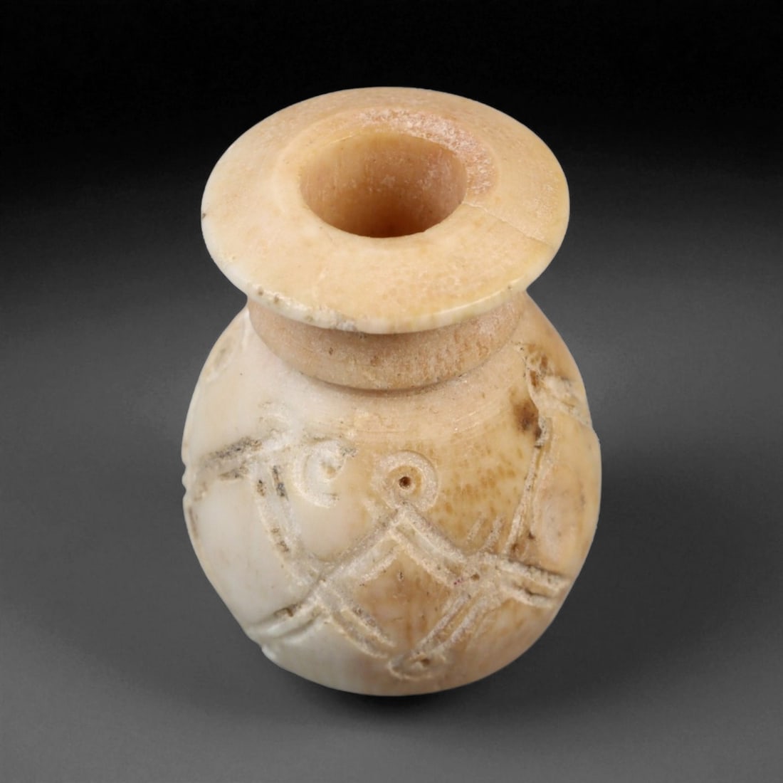 Ancient Medieval Nishapur Silk Road Bone Spindle Whorl, c. 9th-11th Century CE, 1.6cm: This finely carved spindle whorl originates from Nishapur, an important Silk Road city in medieval northeastern Iran, dating to approximately the 9th-11th century CE. Such spindle whorls were essentia