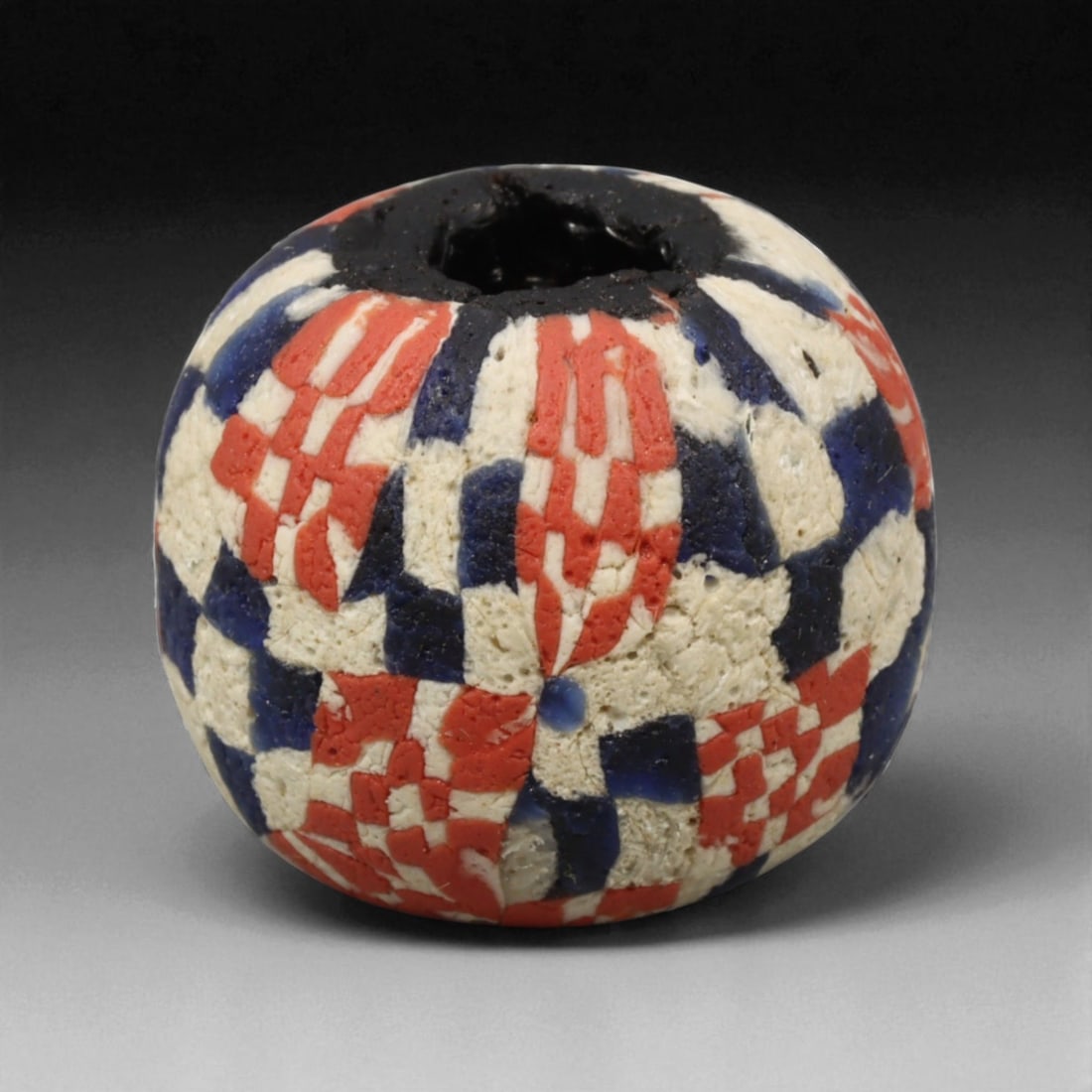 Antique Majapahit Borneo Glass Trade Bead, Southeast Asia, c. 13th-16th Century CE, 2cm: This antique glass bead originates from the cultural sphere of the Majapahit era, a flourishing maritime kingdom that once linked Java, Borneo, and much of Southeast Asia through extensive trade and a
