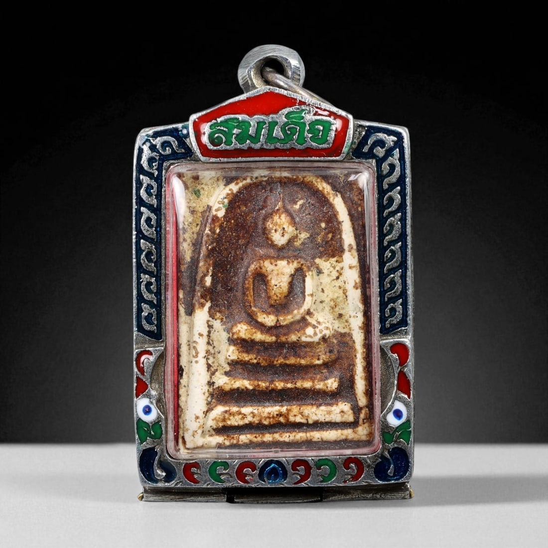 Vintage Thai Buddhist Amulet in Ornate Framed Setting, 20th Century, 6cm: This vintage Thai Buddhist amulet exemplifies the devotional artistry that continues to define Thailand's sacred craftsmanship. Encased within an intricately detailed frame, the amulet displays refine