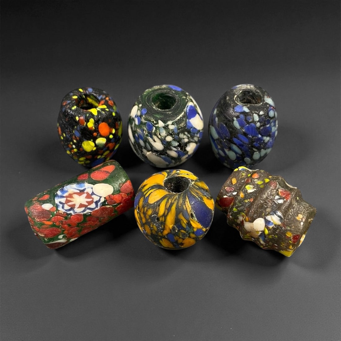 Antique Venetian Millefiori Glass Trade Beads, c. 19th Century, 1.7-2.6cm: This vibrant assemblage of five antique Venetian glass beads captures the height of Murano's decorative artistry during the 19th century. Created using the millefiori and chevron techniques, these bea
