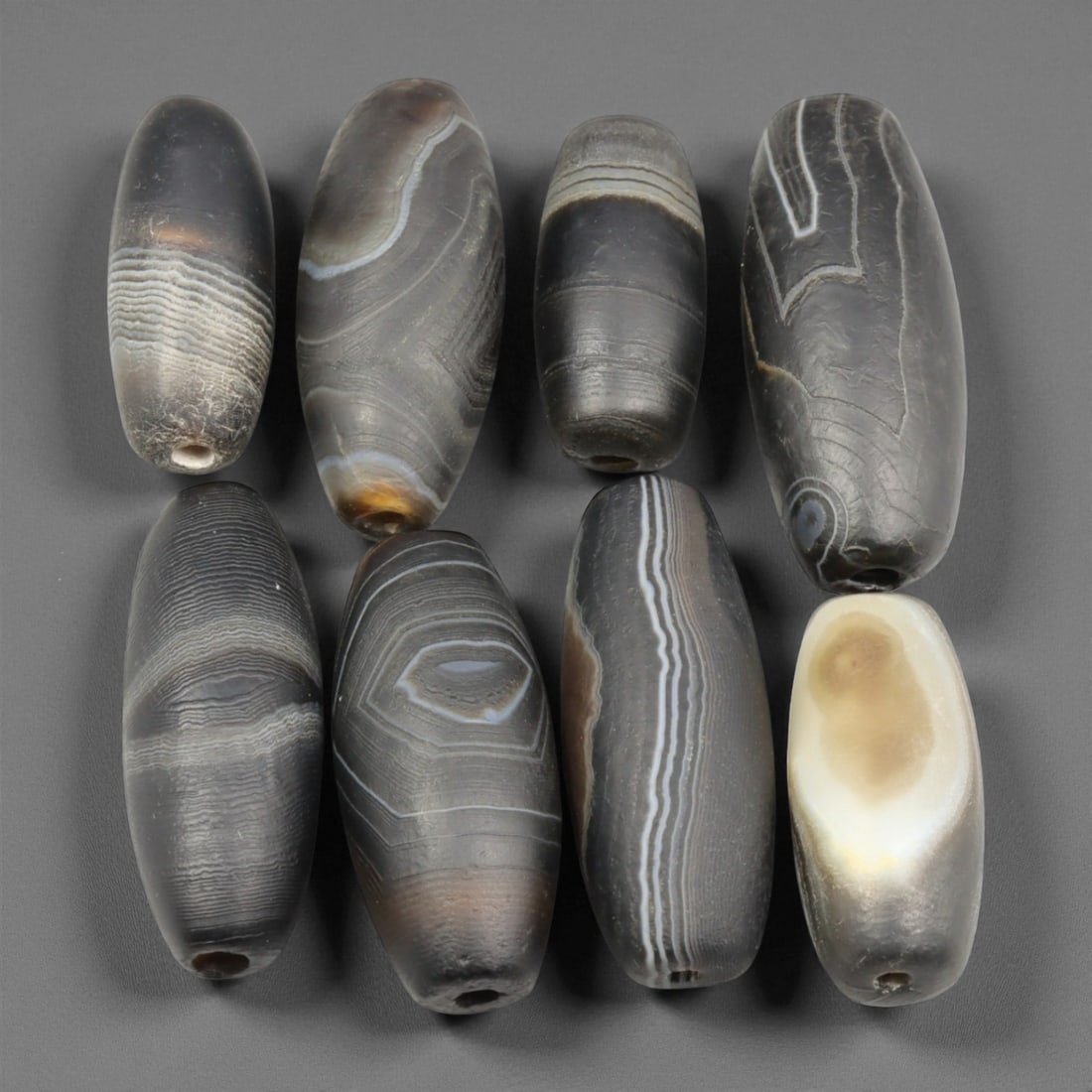 Antique Indo-Tibetan Sulaimani Agate Beads, c. 19th Century, 2.4-3.4cm: This refined collection of antique Sulaimani agate beads dates to the 19th century and originates from the Indo-Tibetan regions, where agate was revered as a sacred and protective stone. Each bead dis