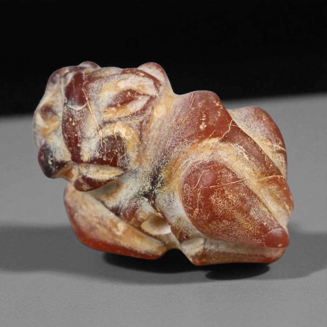 Ancient Indus Valley Lion Agate Amulet, c. 3rd Millennium BCE 2.3cm: This finely carved lion amulet, fashioned from translucent reddish-brown agate, dates to the Indus Valley Civilization, circa 2600-1900 BCE. Representing one of the earliest expressions of animal symb