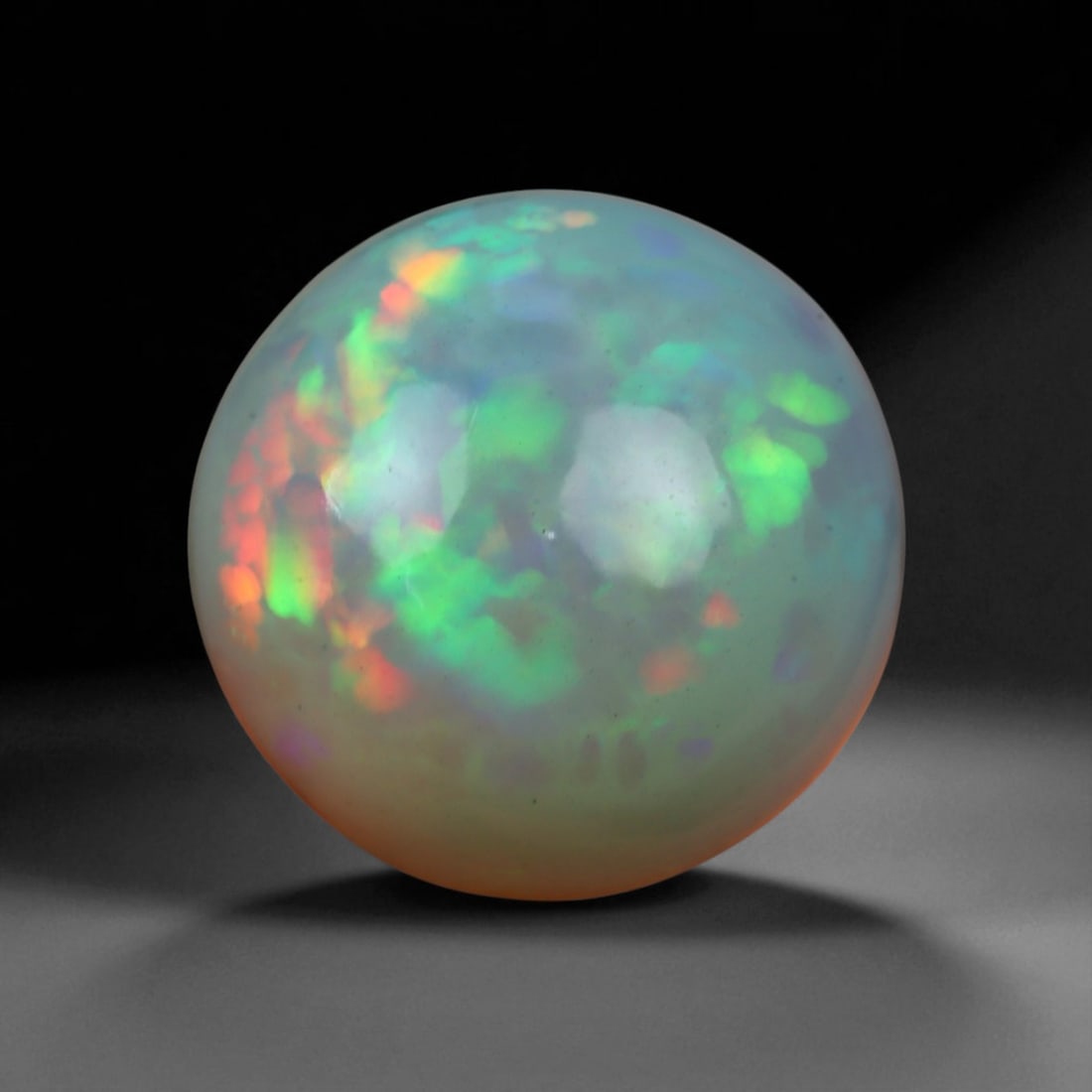 4.95 Carats Multi-Color Welo Opal Lot - Natural Ethiopian Stones: This radiant group of Welo opals displays a mesmerizing interplay of color that dances across the surface with every shift of light. Electric flashes of green, orange, and red ripple through a translu