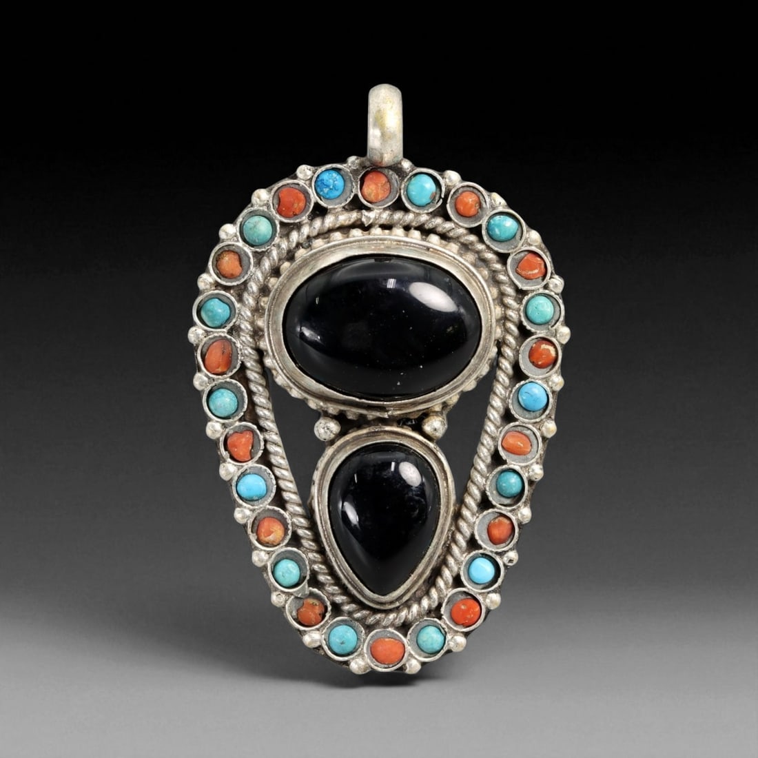 Vintage Himalayan Onyx Coral Turquoise Silver Pendant, 20th Century, 5.2cm: This vintage Himalayan pendant presents a striking interplay of deep black onyx cabochons framed by vibrant coral and turquoise stones. The large oval and teardrop-shaped onyx stones anchor the design