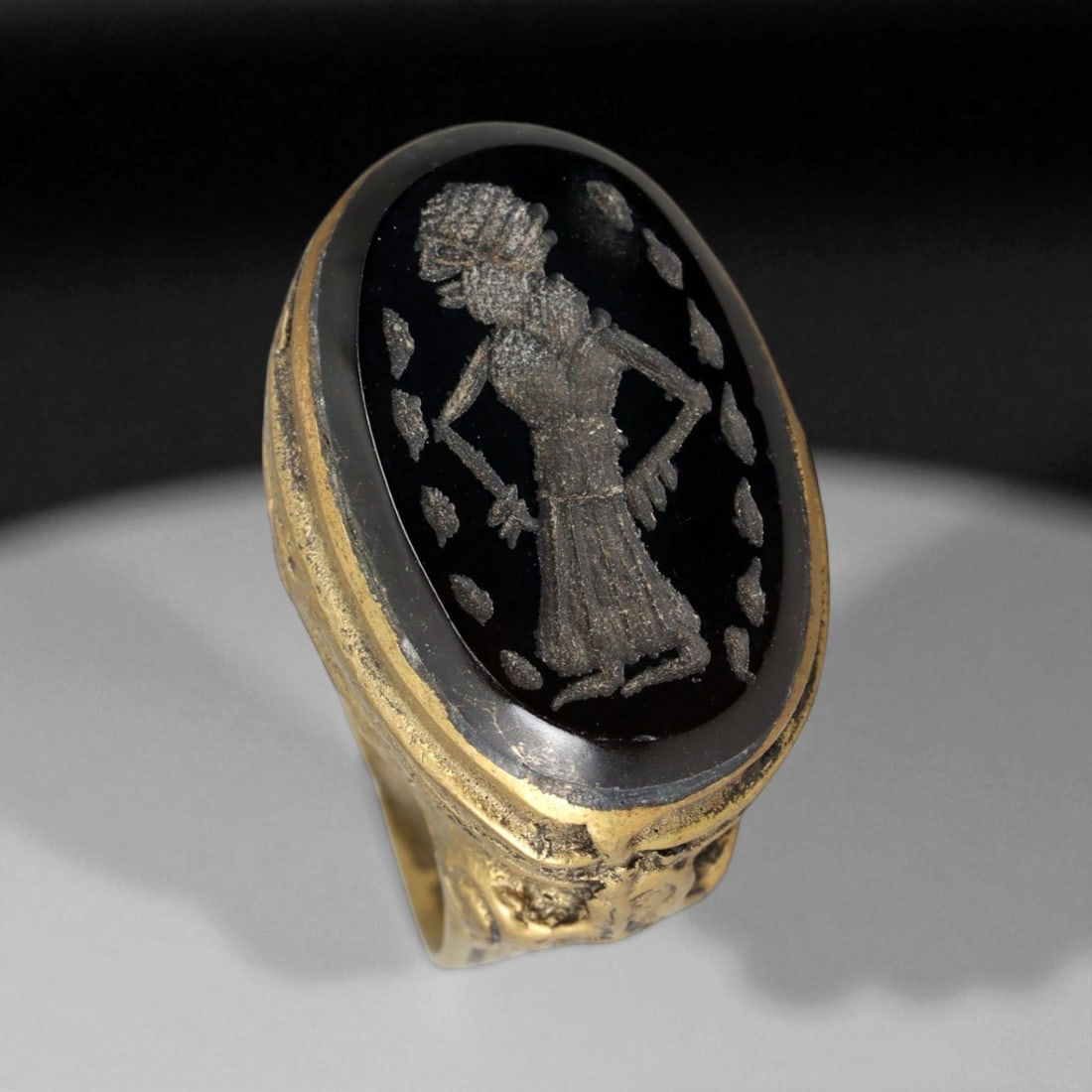 Antique Qajar Gold Gilt Intaglio Signet Ring, c. 19th-20th Century, 8 US: This substantial gilt ring, dating to the Qajar era of the 19th-20th century, embodies the regal aesthetic and cultural refinement of Persian jewelry traditions. The bezel is set with an engraved inta