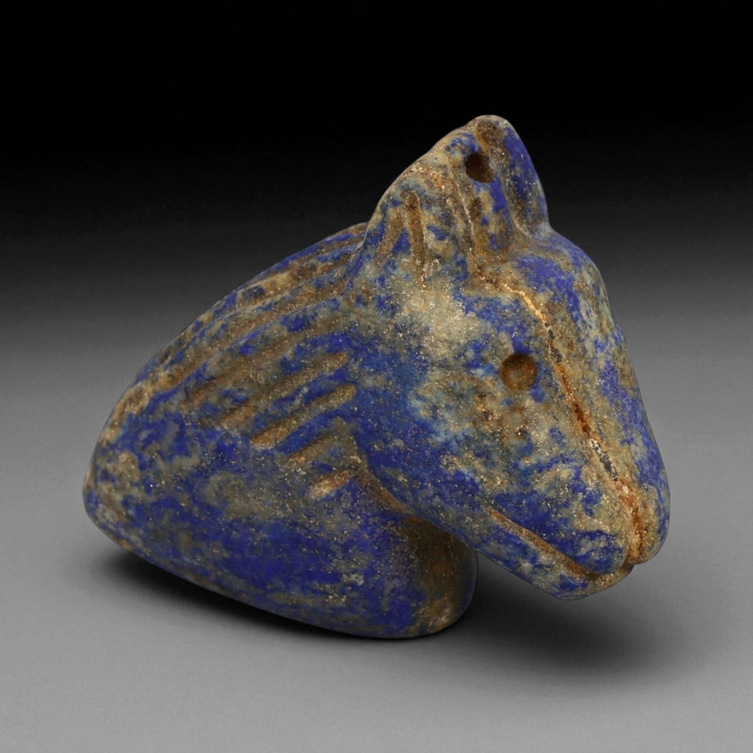 Ancient Bactrian Lapis Lazuli Horse Bust Amulet, c. 2nd-1st Millennium BCE, L 5.5cm: This finely sculpted lapis lazuli effigy of a horse's head originates from ancient Bactria, circa 2nd-1st millennium BCE - a civilization that flourished across modern northern Afghanistan and souther