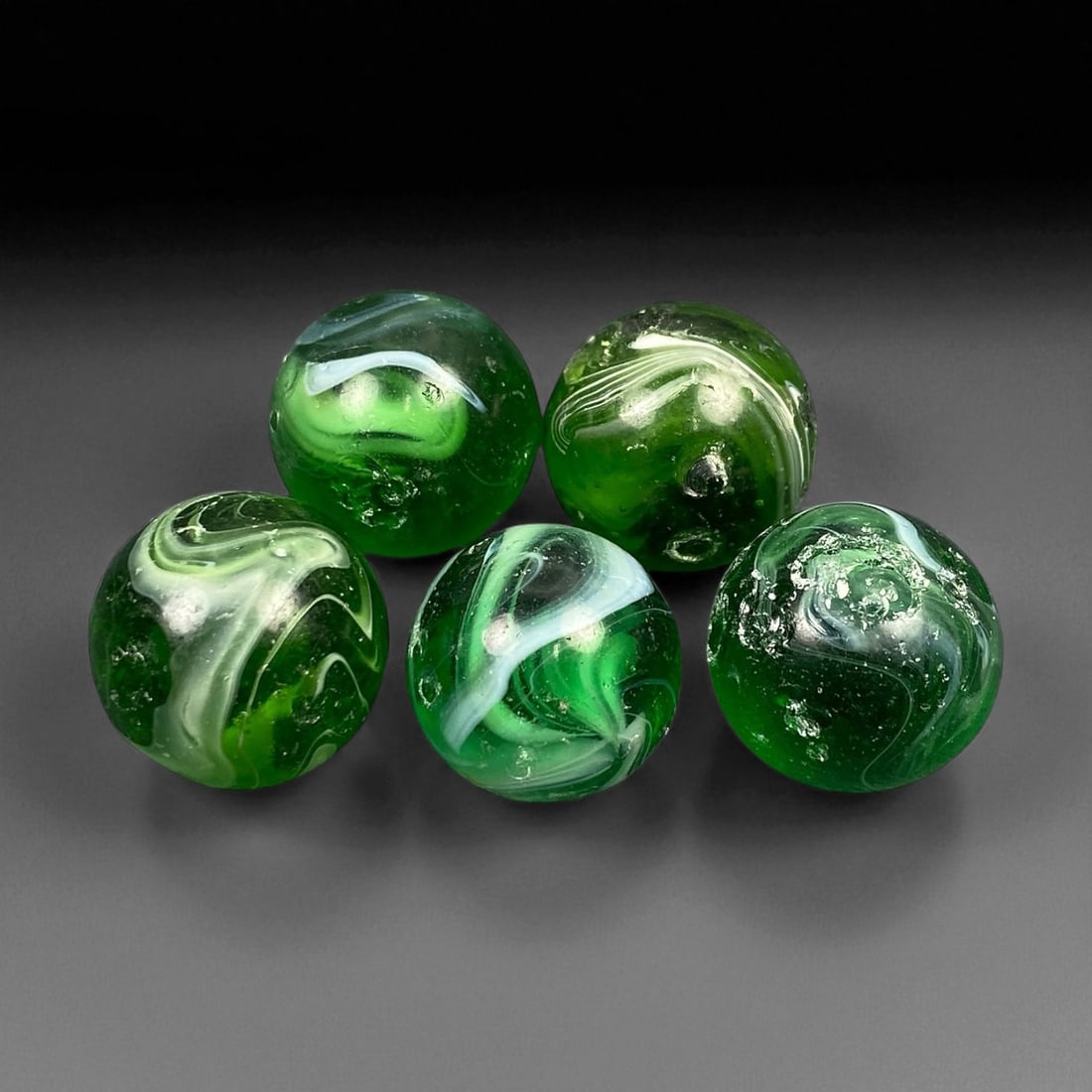 Vintage Glass Marbles Lot, Mid-20th Century, 1.6cm: This charming lot of vintage glass marbles, dating from the mid-20th century, reflects the artistry and playfulness of early handmade and molded glass craftsmanship. These marbles were produced during