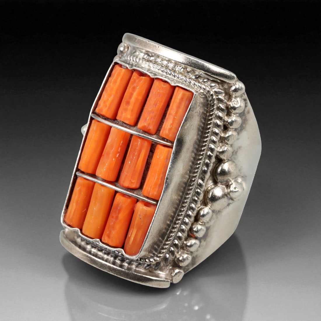 Antique Himalayan Coral Mosaic Silver Ring, c. 19th-20th Century, US Size 9: This striking antique silver ring exemplifies Himalayan artistry from the late 19th to early 20th century, blending symbolic design with tactile craftsmanship. Its rectangular bezel is meticulously in