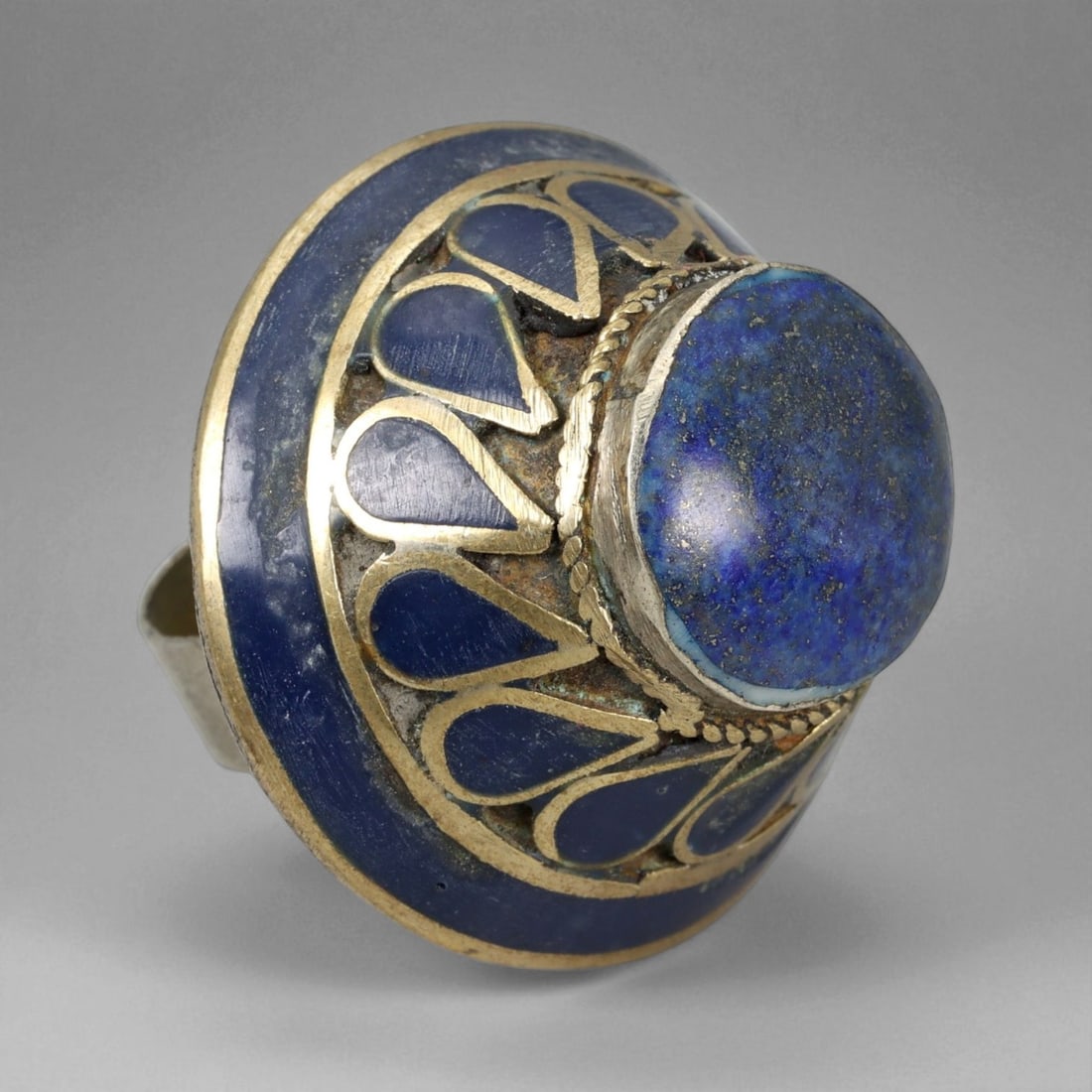 Vintage Himalayan Tribal Lapis Brass Ring, 20th Century, US Size 9: This bold vintage Himalayan ring exemplifies the spiritual elegance and intricate craftsmanship of highland jewelry traditions. Handcrafted in brass, it features a large domed lapis lazuli cabochon at