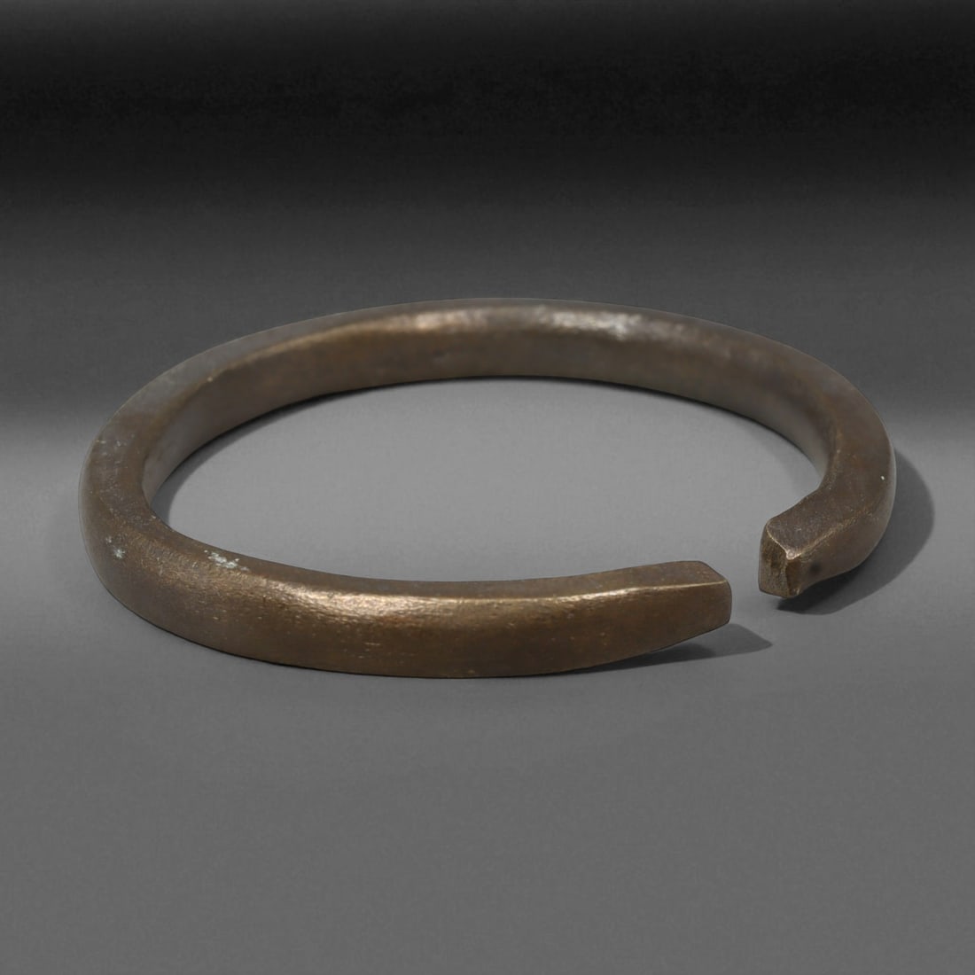 Ancient Sasanian Bronze Bracelet, c. 4th-6th Century CE, 6.4cm: This ancient bronze bracelet dates to the Sasanian Empire, circa 4th-6th century CE, an era celebrated for its refinement of Persian artistry and symbolism. The bracelet's slender, circular form with 