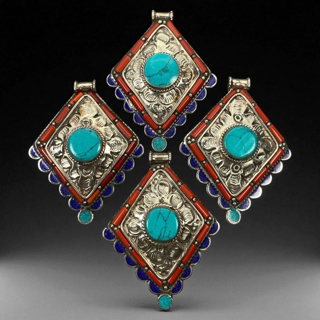 Vintage Himalayan Tribal Pendants, Lot of 4, c. 20th Century, 8 cm: These vintage Himalayan pendants capture the spirit and artistry of traditional jewelry from the highlands of Tibet and Nepal. Crafted with vibrant inlay work and detailed metal framing, they exemplif