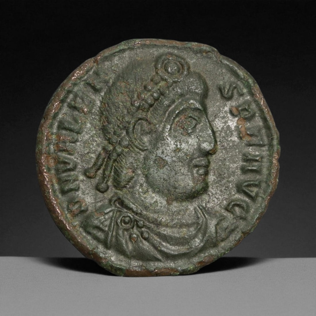 ROMAN EMPIRE: Imperial Authority - Bronze Coin, c. 1st-3rd Century AD, 18mm: Struck during the turbulent decades of the later Roman Empire, this 19mm bronze coin reflects the enduring symbolism of imperial control amidst crisis. Its compact yet deliberate design likely feature