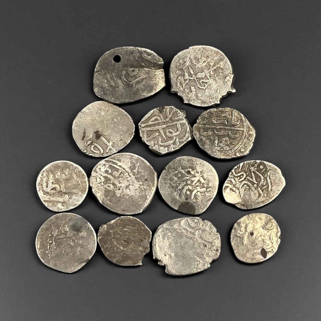 ISLAMIC STATES: Medieval Silver Dirham Lot - Trade and Faith Across the Caliphates: This remarkable lot of hand-struck silver dirhams spans centuries of Islamic civilization, each coin a tangible fragment of a world once united by faith, trade, and scholarship. Struck in radiant yet 