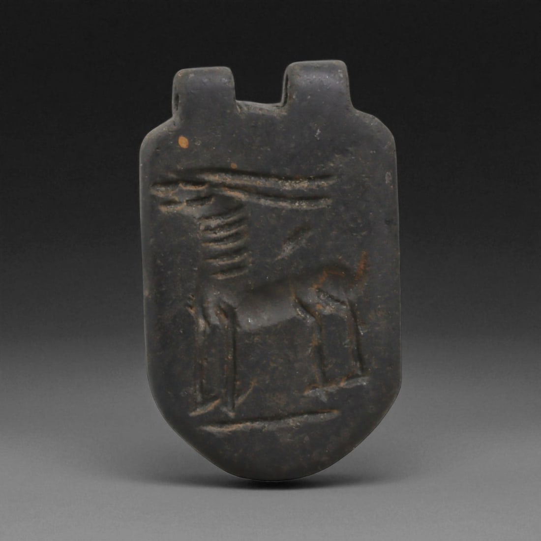 Ancient Near Eastern Relief Amulet Pendant Talisman, c. 2nd-5th Century CE, 4cm: This finely crafted ancient amulet pendant, designed for wear as a personal talisman. The engraved surface bears a carefully incised design, clearly visible when pressed into clay, illustrating its du