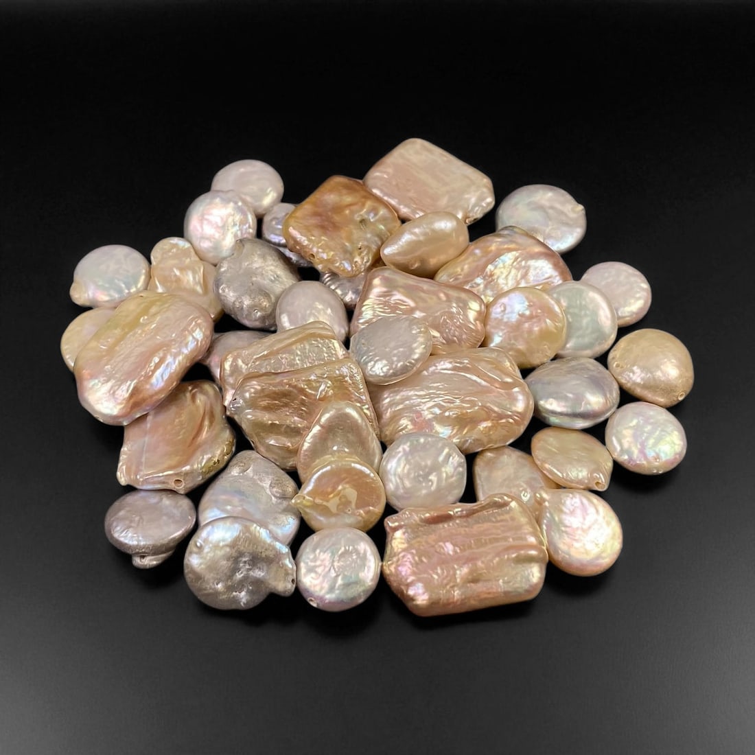 Champagne and Ivory Keshi Pearl Lot - Natural Chinese Origin, 10-12mm: This luminous grouping of natural keshi pearls displays a captivating interplay of champagne, ivory, and soft rose tones across baroque and coin-shaped forms. Each pearl exhibits the organic irregular