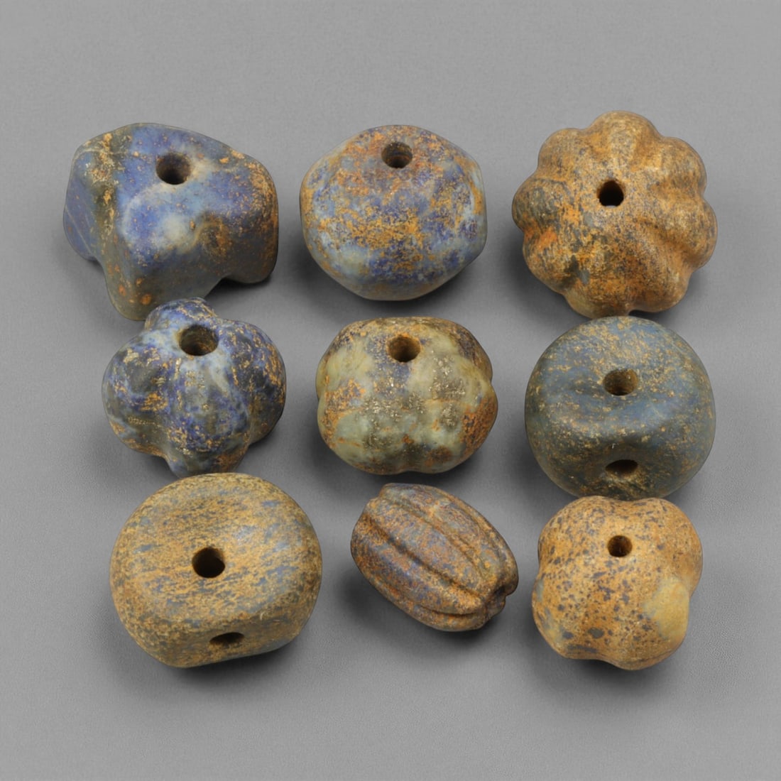 Ancient Bactrian Lapis Lazuli and Stone Beads, c. 2nd Millennium BCE, 1-1.5cm: These ancient Bactrian beads, dating to the 2nd millennium BCE, represent the refined lapidary tradition of one of Central Asia's earliest and most sophisticated civilizations. Crafted primarily from 