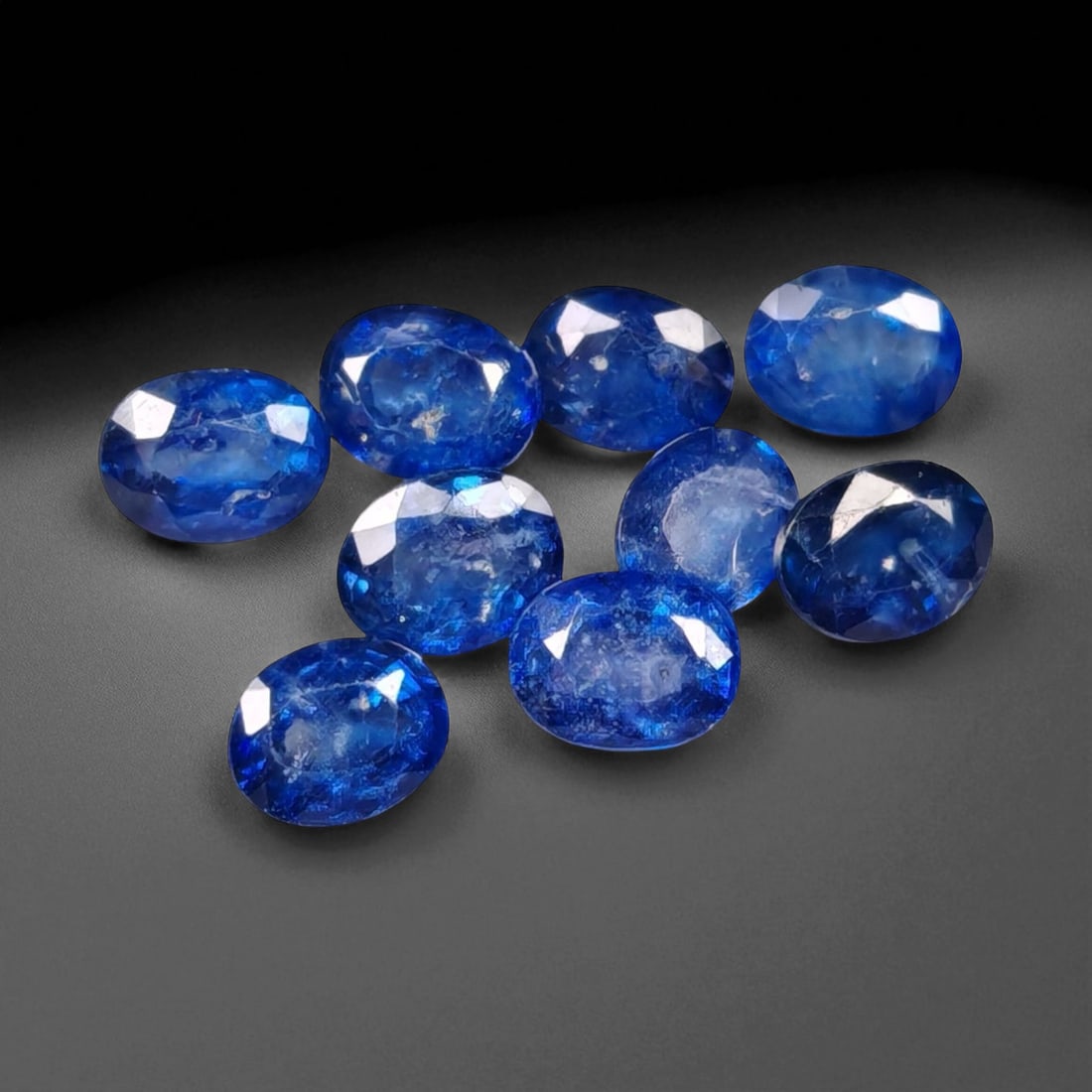 4.00 Carats Royal Blue Sapphire Oval Lot - Natural Ceylon Stones: This captivating lot of oval-cut sapphires exhibits a deep royal blue color, rich and even, with flashes of lighter brilliance across the facets. Each stone, measuring approximately 5x4x2.7mm, is grac