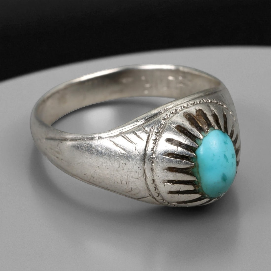 Antique Persian Sunburst Turquoise Silver Ring, c. 19th-20th Century, US 10: This refined antique silver ring captures the enduring symbolism and craftsmanship of Persian jewelry from the late Qajar to early Pahlavi period. Centered with a vivid turquoise cabochon of sky-blue 