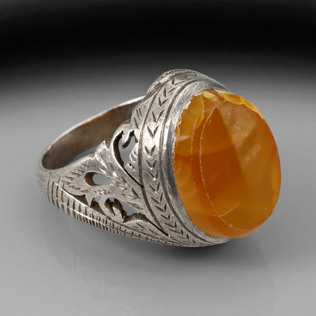 Antique Persian Silver Filigree Ring with Honey Chalcedony Gem, c. 19th-20th Century, US 8.5: This refined antique silver ring reflects the delicate artistry of Persian jewelry from the late 19th to early 20th century, where craftsmanship met spiritual symbolism in every detail. The central ho