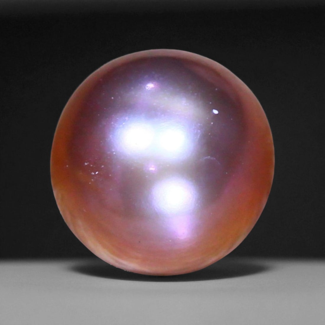 3.51 Carats Violet-Pink Freshwater Pearl - Natural Chinese Gem: This exquisite 7.8mm pearl reveals a striking interplay of violet, pink, and silvery overtones, offering a depth of iridescence rarely seen in natural freshwater pearls. Its surface shows gentle organ