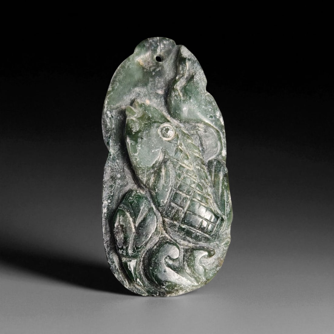 39.51 Carats Deep Green Jade Carved Pendant - Natural Burmese Stone: This beautifully carved jade pendant features a rich, deep green coloration with subtle mottling and natural translucence characteristic of fine jade. Measuring approximately 46.1x21.1x3.7mm, the piec