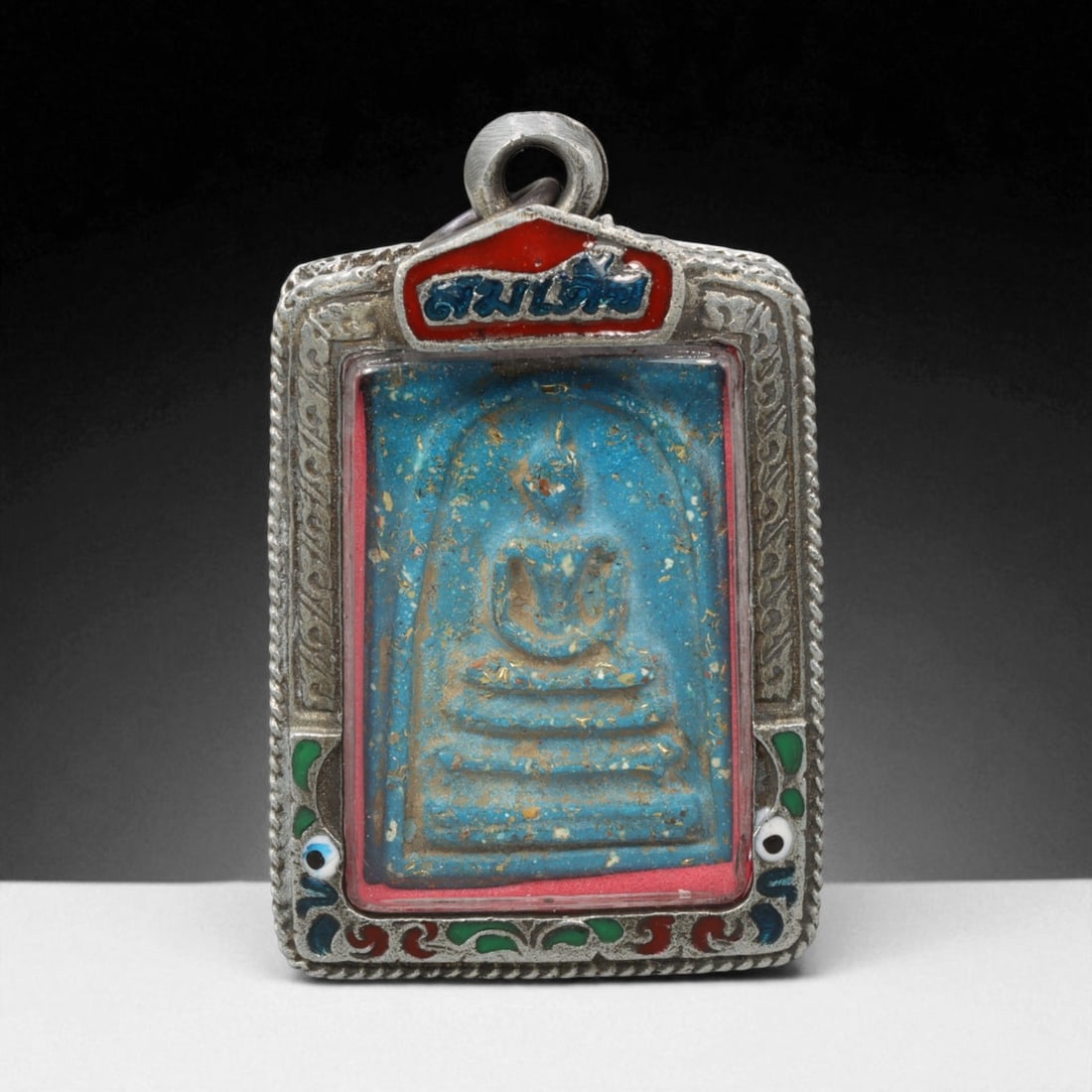 Vintage Thai Buddhist Amulet in Ornate Framed Setting, 20th Century , 5.5cm: This vintage Thai Buddhist amulet exemplifies the devotional artistry that continues to define Thailand's sacred craftsmanship. Encased within an intricately detailed frame, the amulet displays refine