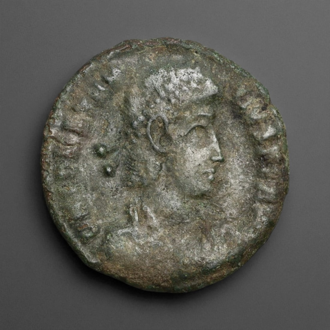 ROMAN EMPIRE: Imperial Authority - Bronze Coin, c. 1st-3rd Century AD, 18mm: Struck during the turbulent decades of the later Roman Empire, this 19mm bronze coin reflects the enduring symbolism of imperial control amidst crisis. Its compact yet deliberate design likely feature