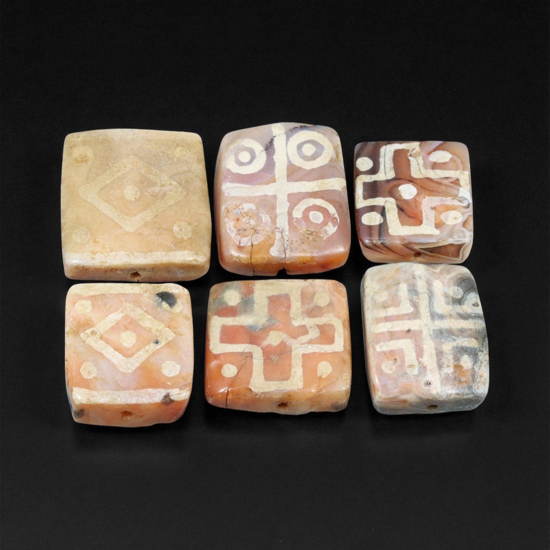 Ancient Silk Road Indo-Himalayan Etched Carnelian Beads, c. 8th-12th Century CE, 2.3-2.6cm: This exceptional group of etched carnelian beads originates from the Indo-Himalayan cultural sphere along the Silk Road, dating to the 8th-12th century CE. These artifacts represent a continuation of 