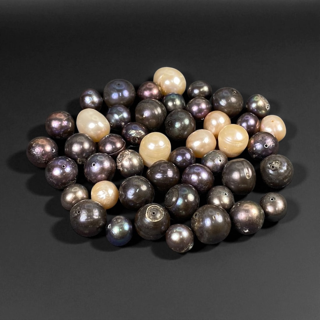 Peacock and Cream Cultured Pearl Lot - Natural Tahitian and Chinese Origins, 7-12mm: This striking collection of cultured pearls presents a refined contrast between deep peacock-black tones and luminous cream hues. The darker pearls shimmer with iridescent flashes of violet, green, an