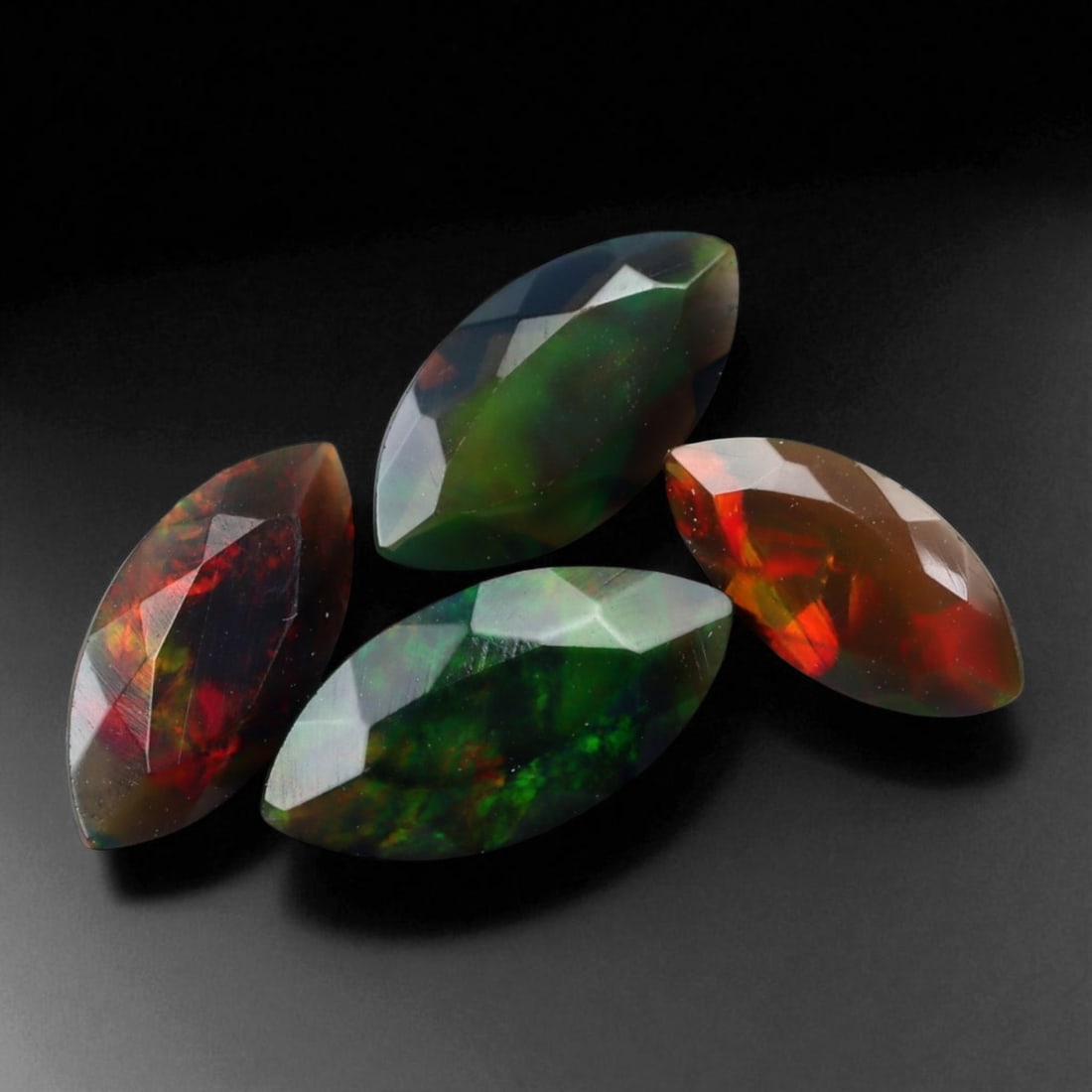 3.40 Carats Dark Fire Opal Faceted Selection - Natural Ethiopian Stones: This dramatic selection of dark Ethiopian opal faceted exhibits a captivating interplay of color set against deep, smoky body tones. Flashes of crimson, emerald, and violet ignite within the stones, p