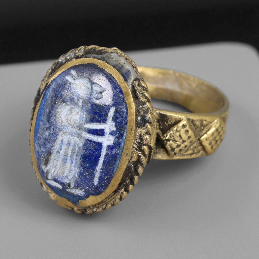 Antique Qajar Gold Gilt Intaglio Signet Ring, c. 19th-20th Century, 8.5 US: This substantial gilt ring, dating to the Qajar era of the 19th-20th century, embodies the regal aesthetic and cultural refinement of Persian jewelry traditions. The bezel is set with an engraved inta