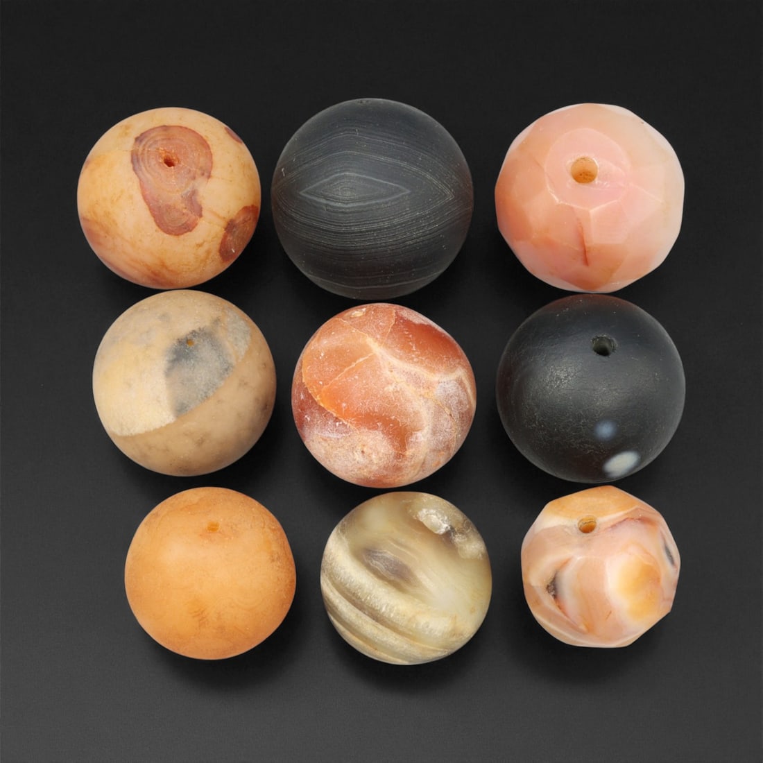Antique Tibetan Agate and Chalcedony Prayer Beads Collection, c. 18th-19th Century, 1.7-2 cm: This graceful assemblage of antique Tibetan beads, carved from agate and chalcedony, dates to the 18th-19th century and embodies the quiet spiritual refinement of Himalayan craftsmanship. Each bead is