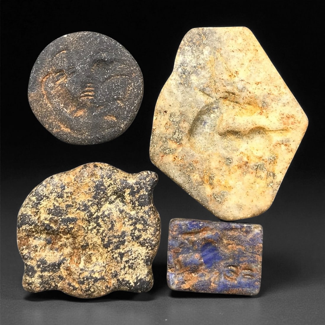 Ancient Mesopotamian Lapis Lazuli and Steatite Stamp Seal Beads Set, c. 2300-1500 BCE, 1.8-3.9 cm: This distinguished group of four ancient stamp seals, carved from lapis lazuli and steatite, dates to the Akkadian-Old Babylonian period, c. 2300-1500 BCE. Each seal embodies the ingenuity of early Me